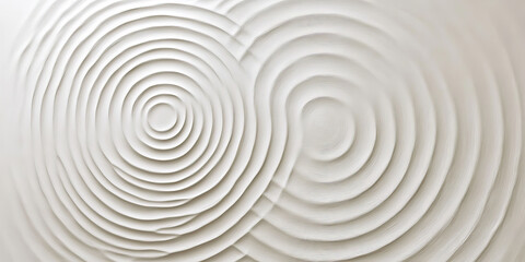 A light white textured surface with a smooth, satin-like finish, accented by faint, concentric circles that radiate outward.
