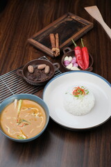 Curry Chicken Rice served in bowl isolated on wooded table top view and side view of Asian food