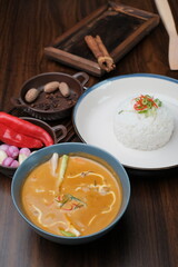 Curry Chicken Rice served in bowl isolated on wooded table top view and side view of Asian food