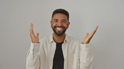 Cheerful young man with a beard poses against a white background, evoking positivity and confidence.