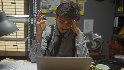 A stressed man with a beard examines documents in a cluttered detective office.