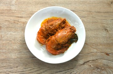 spicy stir fried river shrimp with slice grass leaf curry on plate  