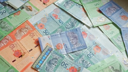 Malaysian ringgit banknotes in various denominations scattered, showcasing the colorful currency from malaysia.