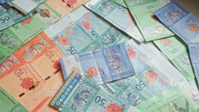 Malaysian ringgit banknotes in various denominations scattered, showcasing the colorful currency from malaysia.