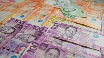 Philippine banknotes in various denominations spread out, showcasing colorful pesos currency from the philippines.