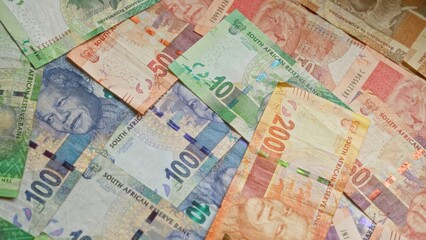 Colorful south african rand banknotes featuring nelson mandela's portrait scattered in a pile showcasing the currency of south africa