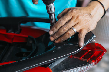 mechanic is servicing a motorbike, mechanic at work