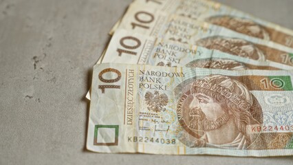 Polish zloty banknotes on a concrete surface displaying narodowy bank polski currency details vividly.