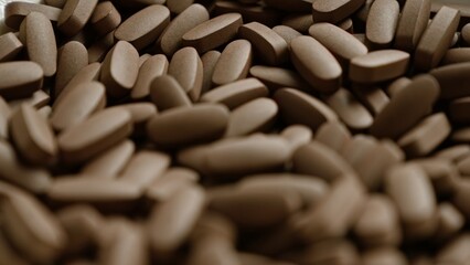 Closeup of brown pills scattered over a surface in a nopeople setting, highlighting the concept of medication and treatment