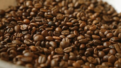 Roasted coffee beans filling the frame, showing their rich brown color and texture, perfect for coffee-themed designs or cafe advertisements