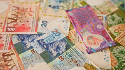 Hong kong dollar close-up, showcasing colorful currency notes spread out in a dynamic arrangement, highlighting the vibrant financial setting of hong kong.
