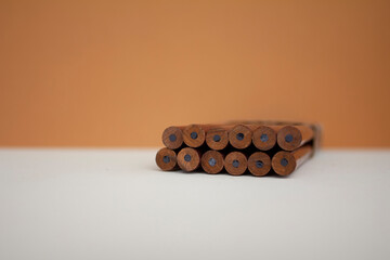 a set of graphic pencils for drawing on a warm background