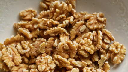 Closeup of shelled walnuts showcasing their texture and detail, highlighting the rich, brown color and healthy nutritional content