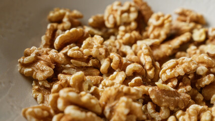 Closeup of shelled walnuts in a bowl showcasing their texture and natural color