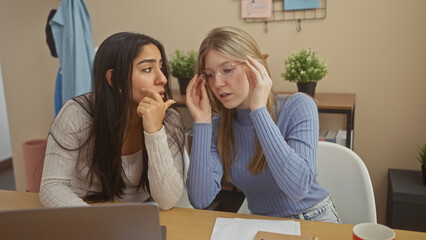 Two women discuss a problem seriously in a modern living room setting, evoking empathy and concern.