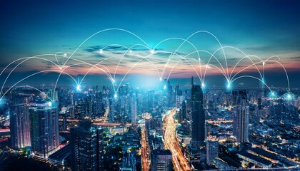 A cityscape at night with white glowing lines connecting buildings, representing a network of connections.