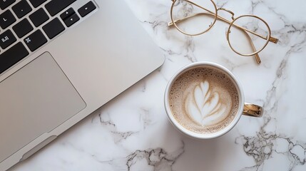 Minimalist scene featuring a laptop open on a desk corner, with a coffee cup and a pair of glasses neatly placed beside it. The bird’s-eye view captures the clean, organized layout, emphasizing simpli