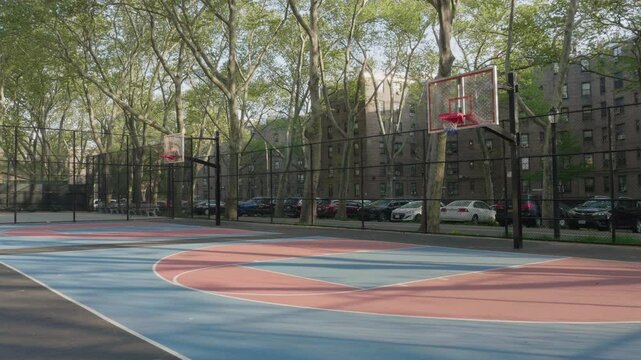 Handheld shot of an empty basketball court in Queensbridge Houses