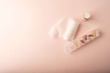 Pills, medical jar and bandage top wiev on pink. Medicine and womens health concept banner. Medicinal treatment deseases. Copy space. High quality photo