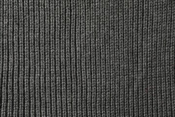 Texture of grey knitted fabric as background, top view