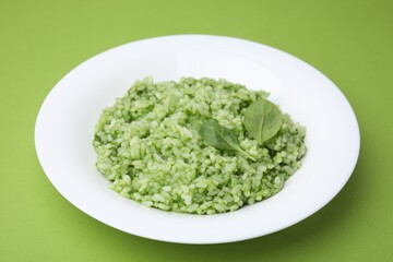 Delicious spinach risotto on light green background