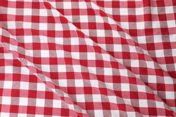 Crumpled checkered tablecloth as background, top view