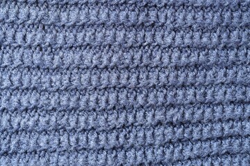Texture of blue knitted fabric as background, top view