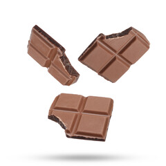 Pieces of sweet chocolate falling on white background