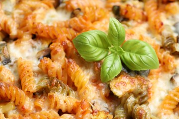 Delicious al forno pasta with basil, closeup