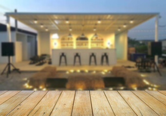 Wooden table top on blur night restaurant or cafe background.For montage product display or design key visual layout.View of copy space.