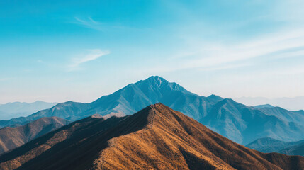 Naklejka premium Majestic mountain vista, expansive clear blue sky, ideal for adventure, tranquil atmosphere, inviting exploration and outdoor activities, perfect for wanderlust seekers.