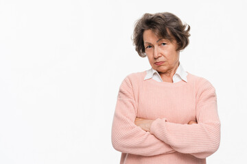 Photo of angry old lady looking suspiciously at camera. Suspicious elderly senior woman showing distrustful look at studio isolated on white background. Mistrustful, trustless, scared, evil person