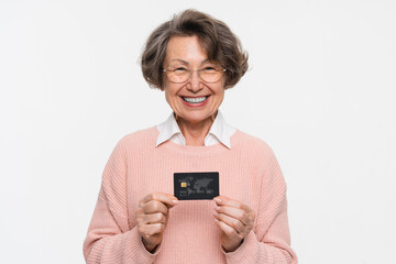 Photo of charming positive smiling old pensioner woman grandmother lady hold hands black premium credit bank card isolated on white color background. Concept of banking, advertisement