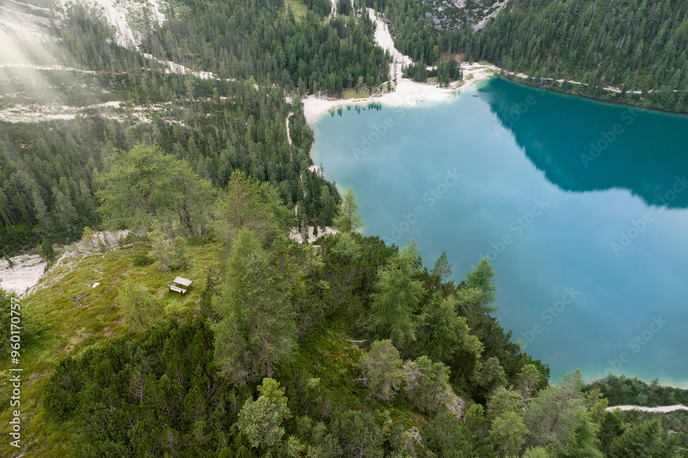 Wall mural aerial view of a wooden bench placed above the braies lake in trentino alto adige italy