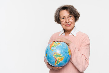 Smiling caucasian mature elderly senior woman holding hugging embracing planet Earth globe to protect save from contamination, war isolated in white background. Geography and traveling concept.