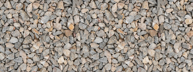 gray stone gravel close-up, uneven cobblestone top view