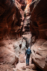 A male hiker embarks on an adventure through the stunning Buckskin Gulch Slot Canyon on the...