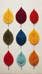 Fototapeta premium A vibrant display of colorful leaves arranged artistically, showcasing various textures and autumn shades on a neutral background.