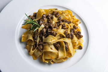Plate with pappardelle with wild boar ragout sauce and rosemary