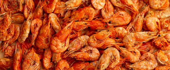 Shrimp close-up in a large pile. Smoked and salted shrimp with spices for a beer snack.