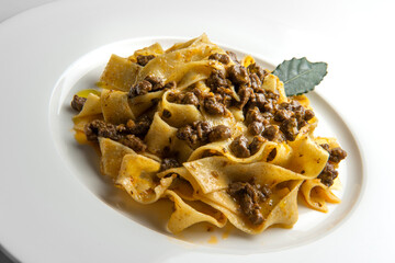 Plate with pappardelle with wild boar ragout sauce with bay leaf