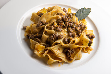 Plate with pappardelle with wild boar ragout sauce with bay leaf