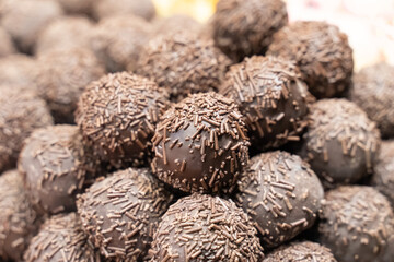 dark chocolate pralines stacked stack close-up, pastry background