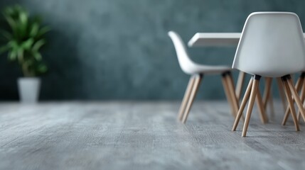 Stylish dining room with contemporary furniture, featuring white chairs and a table, set against a green accent wall, combined with a plant, creating a fresh ambiance.