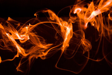 Illustration of orange beautiful smoke on the black background 