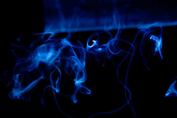 Illustration of blue beautiful smoke on the black background 