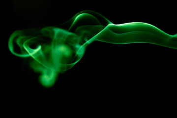 Illustration of green beautiful smoke on the black background 