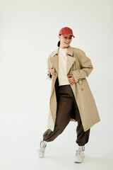A young woman poses confidently in a trendy autumn outfit, embodying the spirit of fall in a serene...