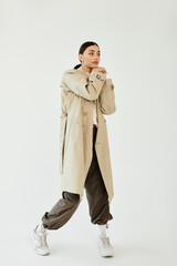 With confidence and flair, a young woman poses in a chic autumn ensemble that embodies the seasonal...
