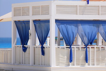 seaside resort beach with white sand and a gazebo for relaxation